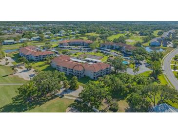 Sprawling condo community offering golf course, tennis courts, lake, and covered parking at 6501 Stone River Rd # 304, Bradenton, FL 34203