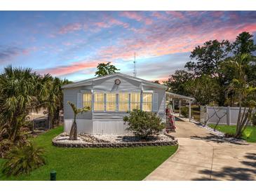 Charming single-story home with well-manicured lawn and inviting curb appeal at 8225 Drew St, Englewood, FL 34224