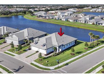 An aerial view of a charming single-Gathering home next to a lake in a well-maintained community at 17902 Cherished Loop, Lakewood Ranch, FL 34211