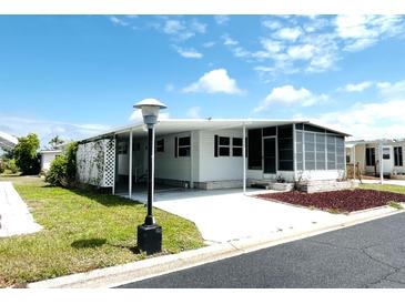 Charming home with a covered driveway and screened porch area at 3221 Sweet Bay Ter, Sarasota, FL 34237