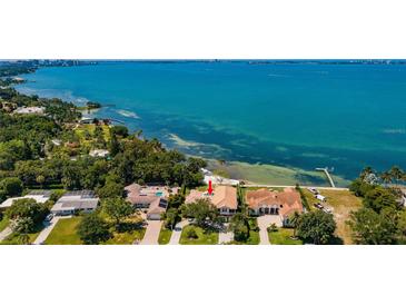 Stunning waterfront property with lush landscaping and beautiful views of the bay at 404 S Shore Dr, Sarasota, FL 34234