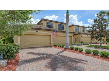 Charming two-story townhome with a well-maintained brick driveway and attached two-car garage at 7019 Grand Estuary Trl # 101, Bradenton, FL 34212