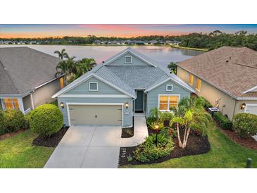 Charming single-Gathering home features a two-car garage, well-maintained landscaping, and a scenic lake view at 7743 Ridgelake Cir, Bradenton, FL 34203
