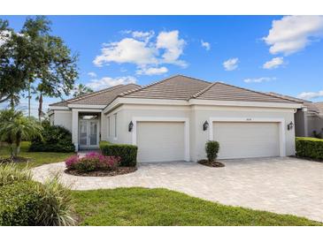 Charming single-story home with a tile roof, beautiful landscaping, and a two-car garage at 8630 51St E Ter, Bradenton, FL 34211