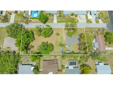 Wide aerial view of the property and surrounding neighborhood, showing ample lot size outlined in white at 275 Burke Rd, Venice, FL 34293