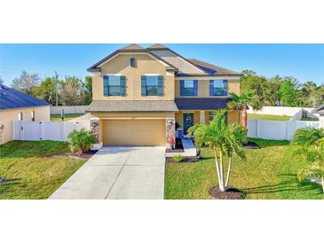 Inviting two-story home featuring well-manicured lawn, attached garage, and charming front-yard landscaping at 4010 Lindever Ln, Palmetto, FL 34221
