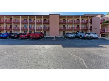 Exterior view of building with parking in front on a sunny day at 4186 Heron Way # B-219, Bradenton, FL 34205