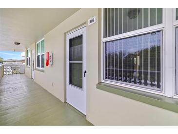 Exterior hallway featuring unit 308's door, a window, and outdoor access at 4885 1St Ne St # 308, St Petersburg, FL 33703