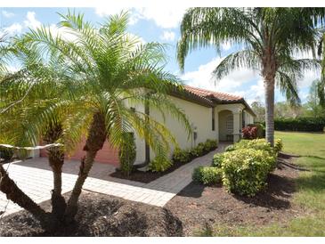 Charming home featuring lush landscaping, a terracotta roof, and a welcoming entryway at 6740 Willowshire Way, Bradenton, FL 34212