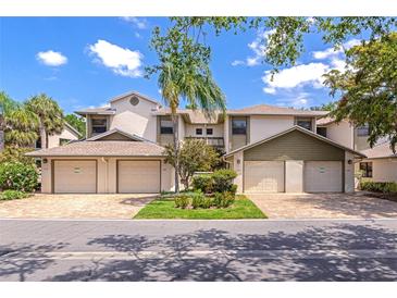 Attractive townhomes with garages and landscaping, creating curb appeal on a sunny day at 1712 Starling Dr # 101, Sarasota, FL 34231