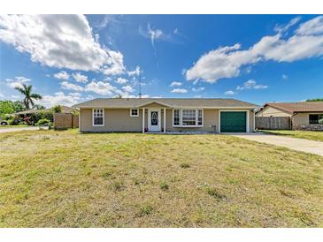 Charming single-story home featuring a well-maintained lawn and a cheerful green garage door at 3119 40Th W Ave, Bradenton, FL 34205