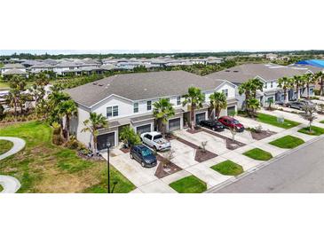 Beautiful exterior view of townhomes with lush landscaping and private driveways at 4781 Vignette Way, Sarasota, FL 34240