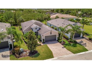 Lovely single Gathering home with beautiful tropical landscaping and brick paved driveway at 5009 Lake Overlook Ave, Bradenton, FL 34208