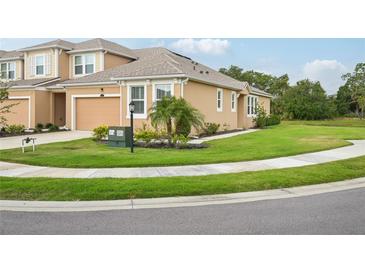 Inviting single-Gathering home boasts well-maintained landscaping and a cozy, neutral-toned exterior at 5520 Coachwood Cv, Bradenton, FL 34211