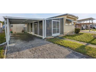 Charming exterior with a carport and screened-in porch for enjoying the outdoors at 1110 49Th Avenue W Dr, Bradenton, FL 34207