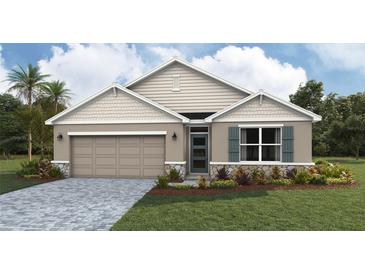 Charming single-Gathering home showcasing stone accents, a two-car garage, and a well-manicured lawn at 1738 Cobb Trl, Parrish, FL 34219
