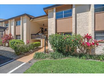 Charming condo exterior featuring lush landscaping, a well-maintained facade, and inviting entryway at 2640 Clubhouse Dr # 204, Sarasota, FL 34232