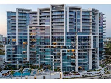 Modern, high-rise condominium building with sleek architectural design, multiple balconies, and views of the city and waterfront at 1155 N Gulfstream Ave # 706, Sarasota, FL 34236