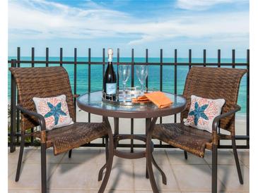 Relax on this condo balcony and enjoy ocean views while seated at the table with seating for two at 1212 Benjamin Franklin Dr # 901, Sarasota, FL 34236