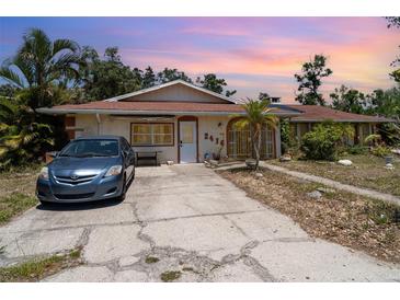 Charming single-story home featuring a spacious driveway and well-maintained front yard with mature trees at 2417 6Th Avenue E Dr, Bradenton, FL 34208