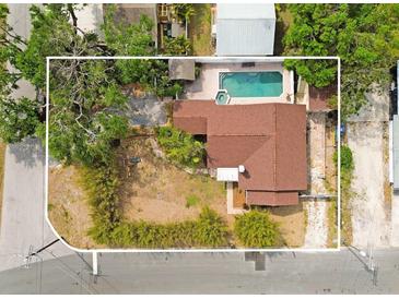 An aerial view showcases this cozy home and its private backyard pool with a spa, creating a perfect outdoor retreat at 316 29Th W St, Bradenton, FL 34205
