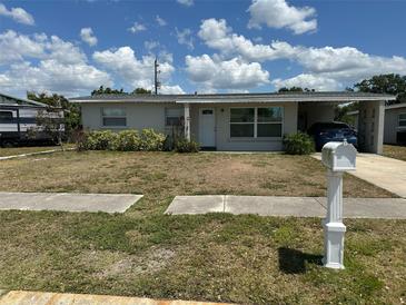 Charming single-story home featuring a carport and well-maintained landscaping at 3713 Stokes Dr, Sarasota, FL 34232