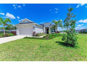 Charming single-story home boasts a lush lawn and tropical landscaping at 4324 Sea Marsh Pl, Parrish, FL 34219