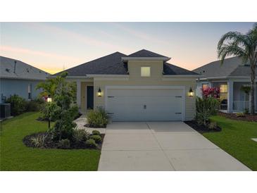 Charming single-Gathering home featuring a two-car garage, well-maintained lawn, and beautiful landscaping at 4839 Deep Creek Ter, Parrish, FL 34219