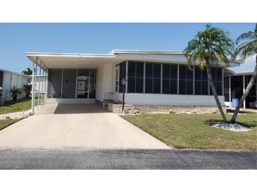 Charming single-story home featuring a screened-in porch, mature landscaping, and a cozy curb appeal at 5536 Denmark Dr, Bradenton, FL 34207