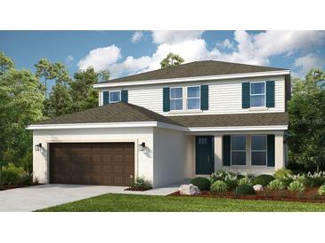 Charming two-story home with attached garage, lush landscaping, and classic design elements at 7053 Foxboro Way, Nokomis, FL 34275