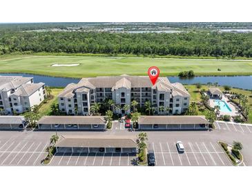 Beautiful condo building overlooks golf course, lake, community pool and covered parking at 17810 Gawthrop Dr # 406, Bradenton, FL 34211