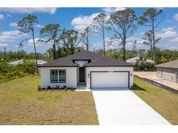 Charming single-story home with a two-car garage and well-manicured lawn at 2290 Beeville Ave, North Port, FL 34286