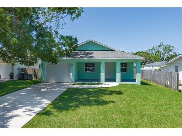 Charming single-story home featuring a well-manicured lawn and a welcoming front porch at 3712 19Th E St, Bradenton, FL 34208