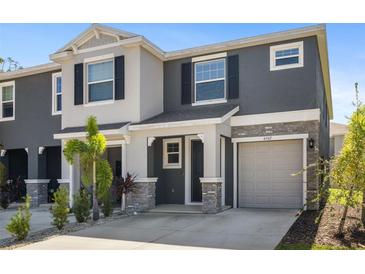 Charming two-story townhome with a garage and landscaping at 6567 Calypso Coral Ln, Sarasota, FL 34240
