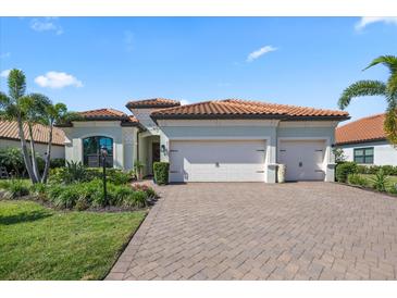 Lovely home with a three-car garage, clay tile roof and lush landscaping at 7113 Whittlebury Trl, Bradenton, FL 34202