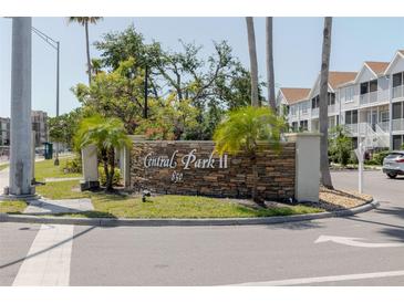 Community sign for Central Park II with lush landscaping and palm trees on a sunny day at 850 S Tamiami Trl # 836, Sarasota, FL 34236