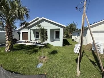 Charming single-story home with well-manicured lawn and a palm tree in the front yard at 8810 N Mulberry St, Tampa, FL 33604