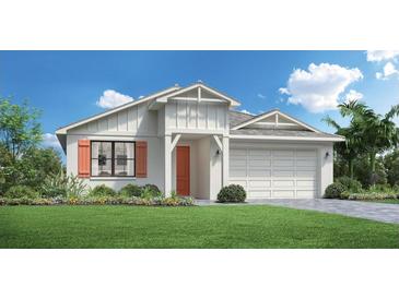 Charming single-story home with a manicured lawn, orange shutters and a two-car garage at 12876 Morning Mist Pl, Venice, FL 34293