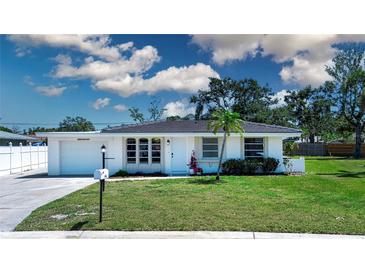 Charming single-story home with a well-manicured lawn, updated roof, and lovely landscaping at 466 Sunnyside Dr, Venice, FL 34293