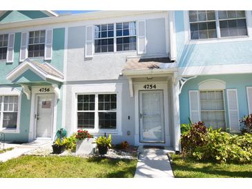 Charming multi-colored townhome featuring a well-manicured lawn and bright curb appeal at 4754 Sabal Key Dr, Bradenton, FL 34203