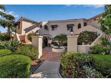 Charming condo featuring a lovely front garden, fountain, and red awnings at 6101 34Th W St # 9C, Bradenton, FL 34210