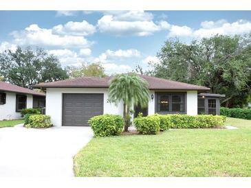Charming single-story home featuring a well-manicured lawn and mature landscaping at 2614 67Th W St, Bradenton, FL 34209