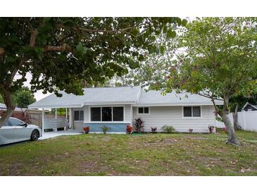 Charming single-story home with well-maintained lawn and mature trees, freshly painted in neutral tones at 2722 Nancy St, Sarasota, FL 34237