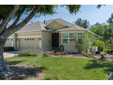 Inviting single-story home with attached two-car garage, well-manicured lawn, and lush landscaping at 3312 92Nd E Ave, Parrish, FL 34219
