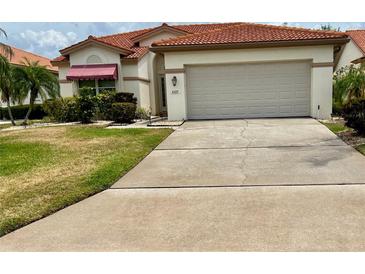 Charming single-story home with a two-car garage and a beautiful terracotta roof at 4729 Peridia E Blvd, Bradenton, FL 34203
