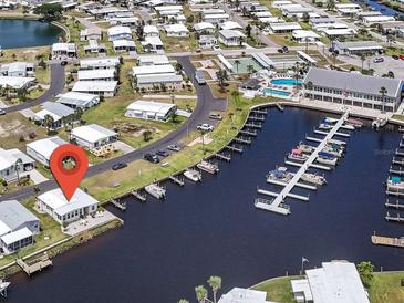Waterfront home with boat dock offers canal access, golf course, and a community pool at 517 Tampico Dr, North Port, FL 34287