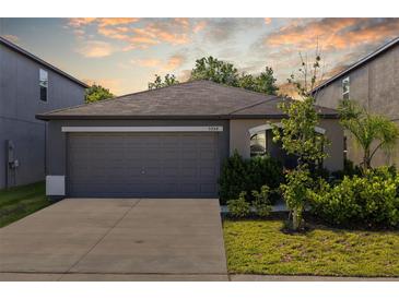 Charming one-story home with a two-car garage and well-maintained landscaping at 5554 Blue Azure Dr, Wimauma, FL 33598