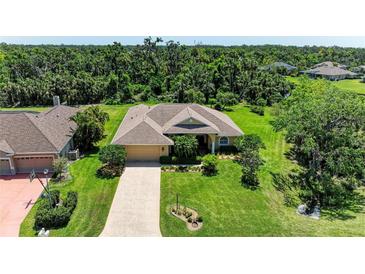 Beautiful single-story home featuring lush landscaping, a paver driveway, and an attached two-car garage at 5616 90Th Avenue E Cir, Parrish, FL 34219