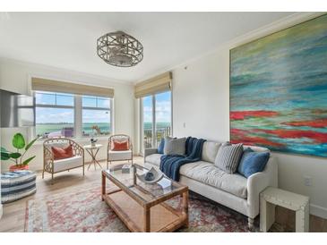 Comfortable living area with scenic water view windows, casual seating and contemporary decor at 750 N Tamiami Trl # 1203, Sarasota, FL 34236