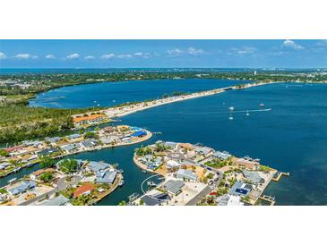Stunning aerial view of waterfront home with private dock on beautiful blue bay near a beach at 10008 Spoonbill E Rd, Bradenton, FL 34209